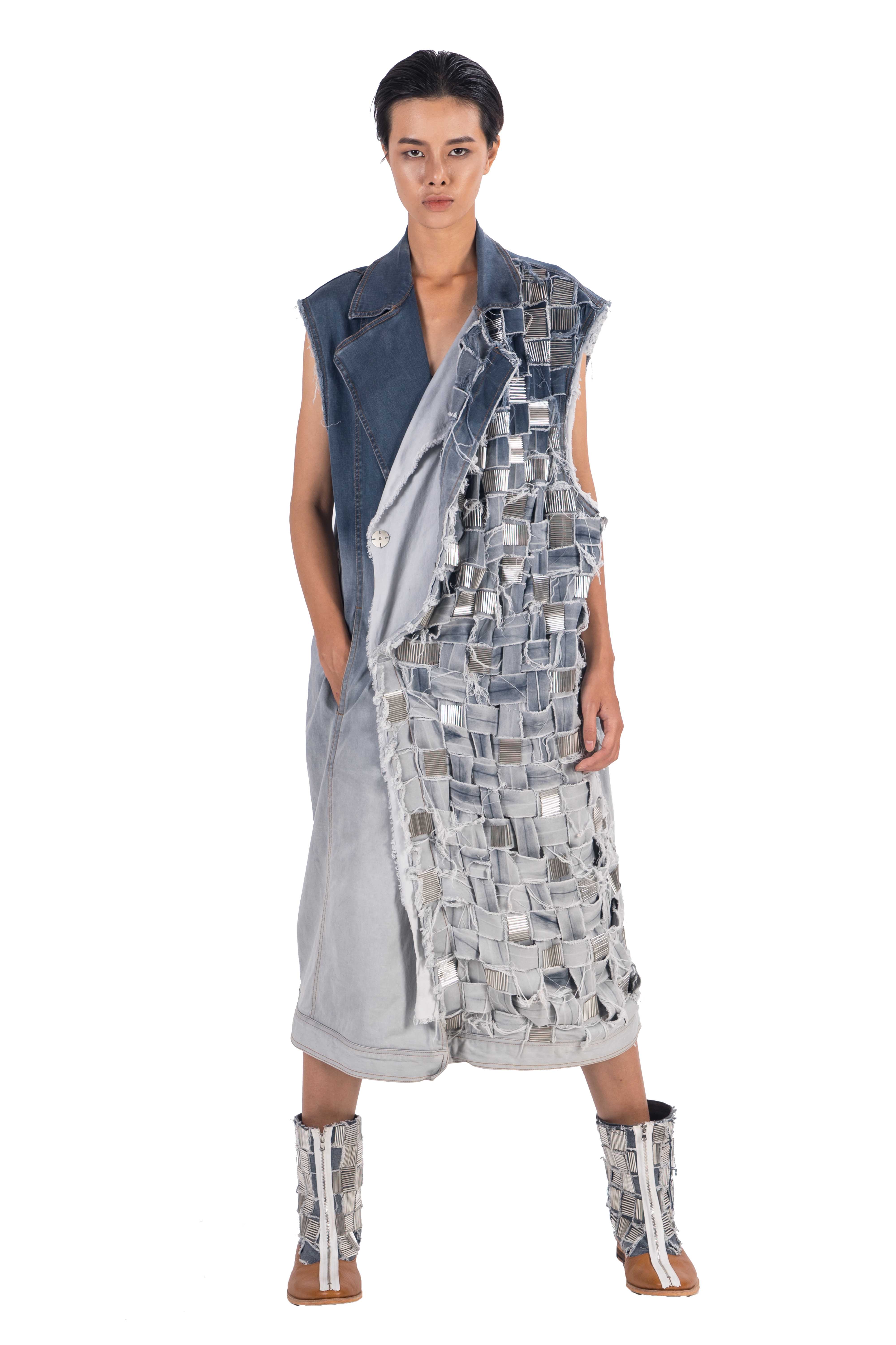 Long sleeveless distressed denim double breasted coat with hand woven front left handside panel with hand applied embellishement