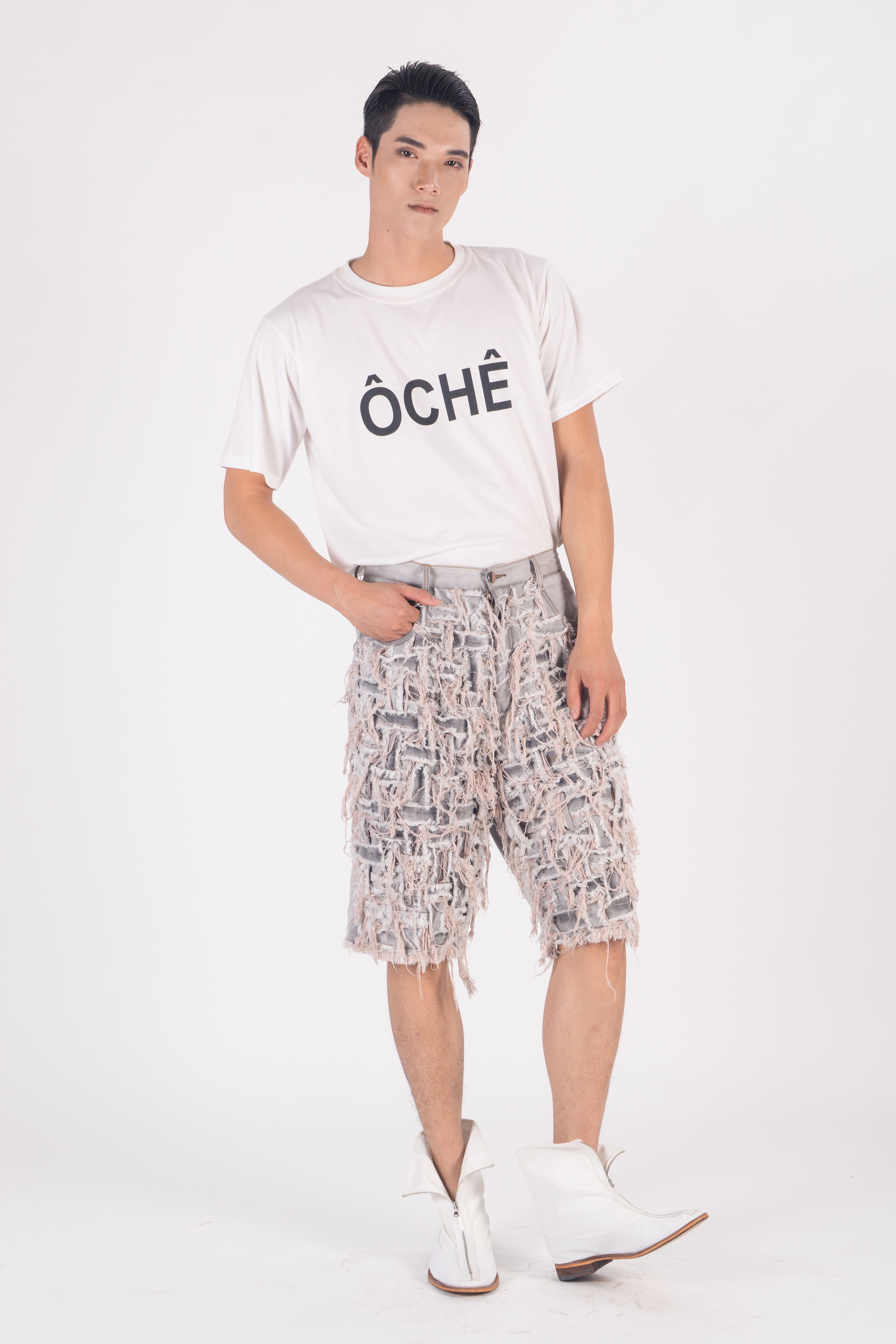 Distressed washed denim shorts with front hand woven and ripped effect