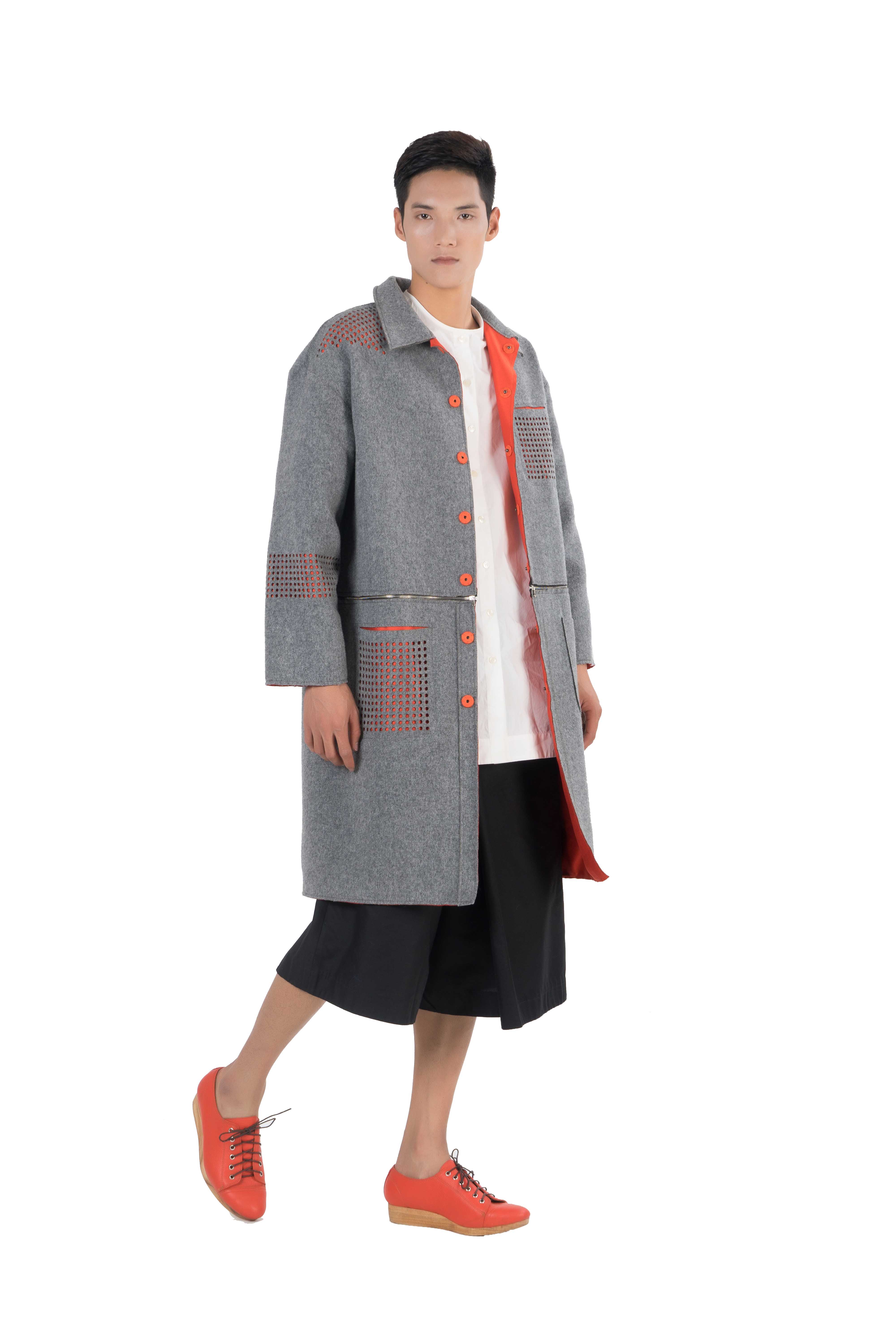 Grey wool blend coat with contrasting orange taffeta lining and see through laser cut detailing
