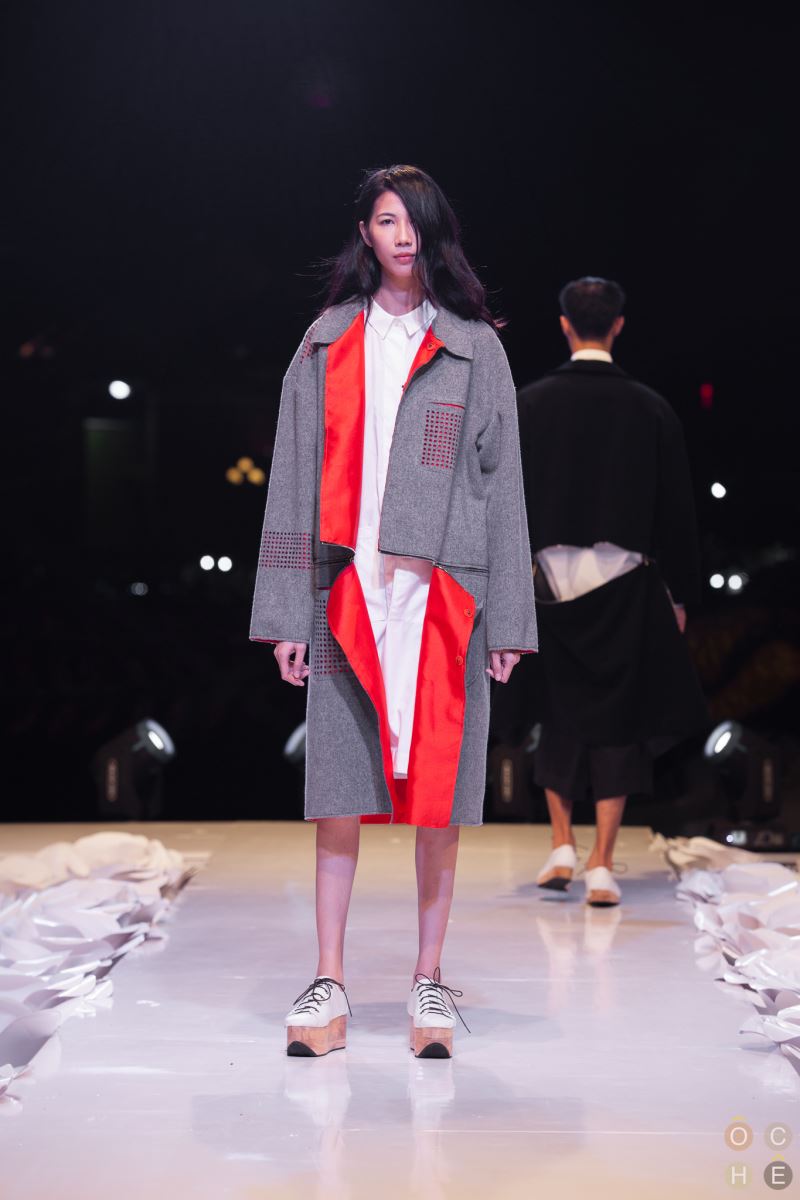 Grey wool blend coat with contrasting orange taffeta lining and see through laser cut detailing